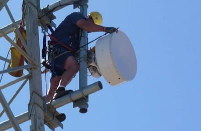 wave1 staff installing a wireless microwave